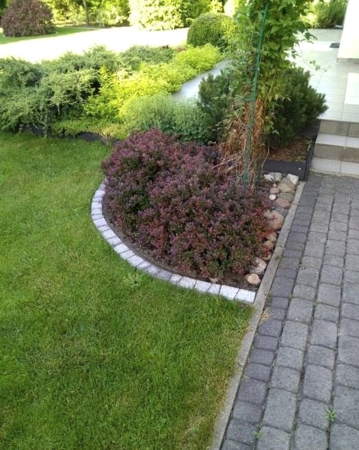 Opaska z kostki granitowej wokół rabaty przy ścieżce z kostki